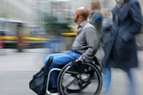 Man in wheelchair in city